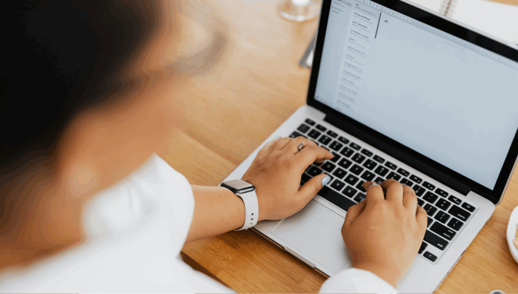 Chat support agent managing multiple customer chats on a laptop.